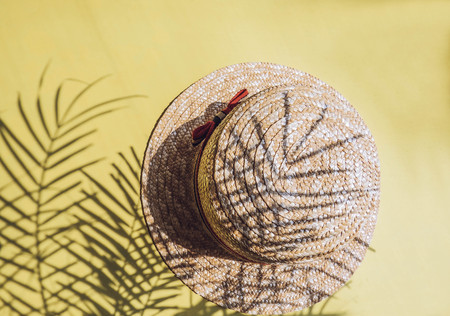 Holiday, vacation tropical beach from above - palm tree leaves and a straw hat. seashells. Style Top View Group Objectsの写真素材