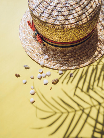 Holiday, vacation tropical beach from above - palm tree leaves and a straw hat. seashells. Style Top View Group Objectsの写真素材