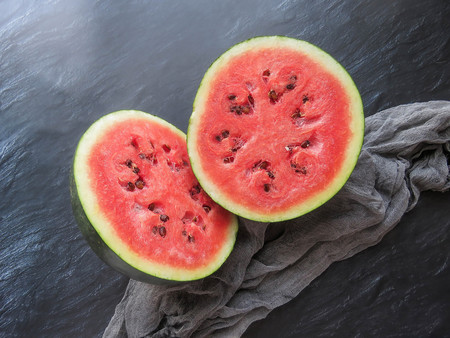 ripe red watermelon on a dark background Summer food background healthy eating. eco-friendly products. organic fruits. copyspace. Organic Food. Style Top Viewの写真素材