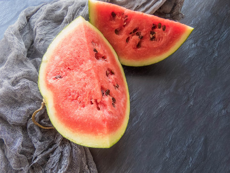 ripe red watermelon on a dark background Summer food background healthy eating. eco-friendly products. organic fruits. copyspace. Organic Food. Style Top Viewの写真素材