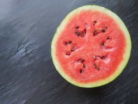 ripe red watermelon on a dark background Summer food background healthy eating. eco-friendly products. organic fruits. copyspace. Organic Food. Style Top Viewの写真素材