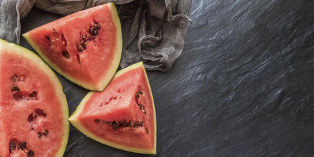 ripe red watermelon on a dark background Summer food background healthy eating. eco-friendly products. organic fruits. copyspace. Organic Food. Style Top Viewの写真素材