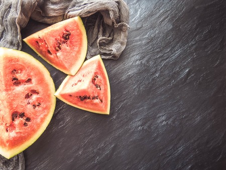 ripe red watermelon on a dark background Summer food background healthy eating. eco-friendly products. organic fruits. copyspace. Organic Food. Style Top Viewの写真素材