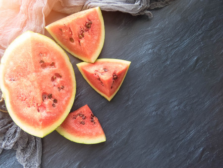 ripe red watermelon on a dark background Summer food background healthy eating. eco-friendly products. organic fruits. copyspace. Organic Food. Style Top Viewの写真素材