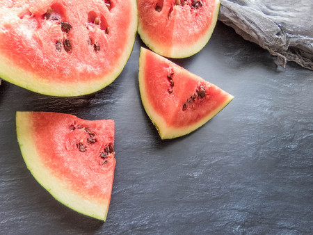 ripe red watermelon on a dark background Summer food background healthy eating. eco-friendly products. organic fruits. copyspace. Organic Food. Style Top Viewの写真素材