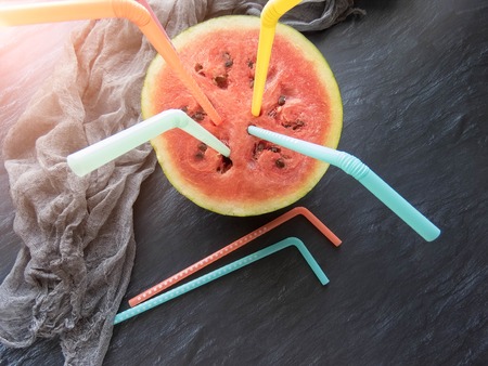 ripe red watermelon with colorful tubules Summer food background healthy eating. eco-friendly products. organic fruits. copyspace. Organic Food. Style Top Viewの写真素材