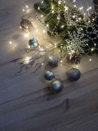 Winter still life with garland, balls, pine and cones on a white wooden background top view. christmasの写真素材