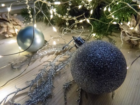 Winter still life with garland, balls, pine and cones on a white wooden background top view. christmasの写真素材