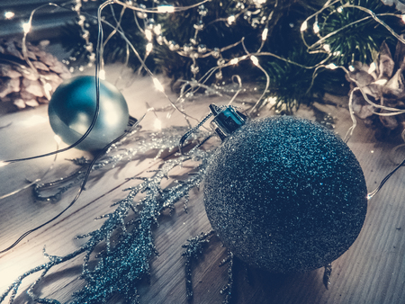 Winter still life with garland, balls, pine and cones on a white wooden background top view. christmasの写真素材