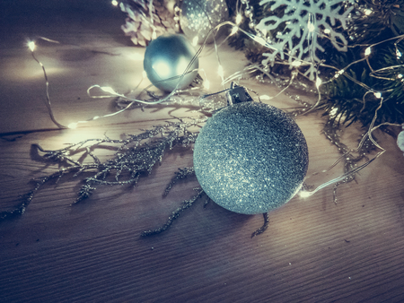 Winter still life with garland, balls, pine and cones on a white wooden background top view. group of objects christmasの写真素材