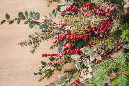 Christmas attributes pine cone and holly berries on the Christmas-tree branch. group of objectsの写真素材