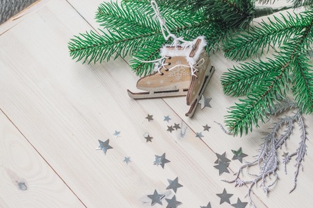 wooden toy skates on a white wooden background with christmas tree space for textの写真素材