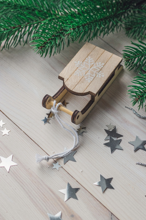 Santa Claus sleigh on a white wooden background with christmas tree space for textの写真素材