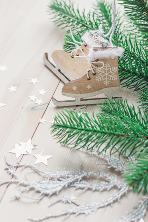 wooden toy skates on a white wooden background with christmas tree space for textの写真素材