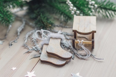 Santa Claus sleigh and socks on a white wooden background with christmas tree space for textの写真素材