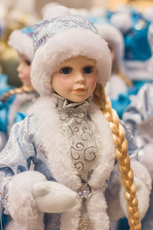 Christmas girl dolls, snow maiden for presesents or decoration, carry gifts sale, market, realization in the shop, supermarketの写真素材