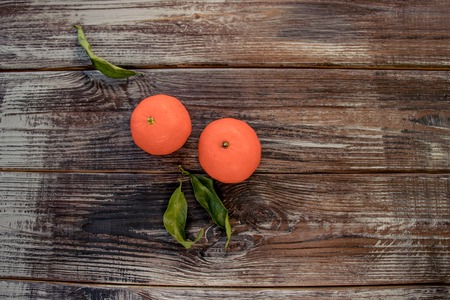 Mandarins Tangerines on wooden background. Free space for your text. color of the year 2019 Living Coralの写真素材
