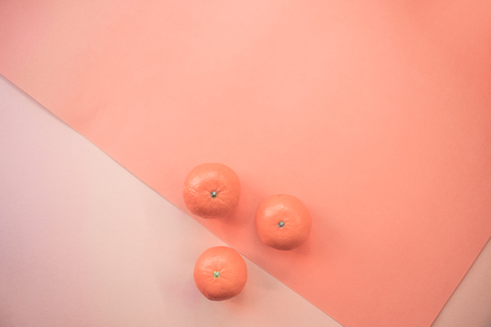 Banner with the color of the year 2019 - Live Coral. Three mandarins. Place for text. Eco concept. Fresh tangerines on color background. Color of the year 2019 Living Coralの写真素材