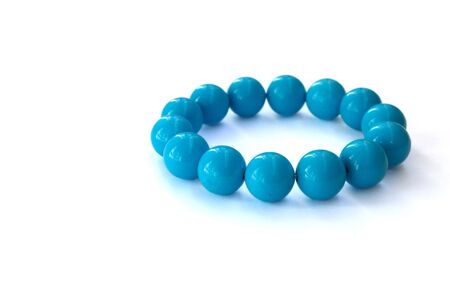 The blue bracelet made of turquoise on a white backgroundの写真素材