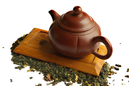 Clay teapot for the Chinese tea and green tea,on the wooden desk and white backgroundの写真素材