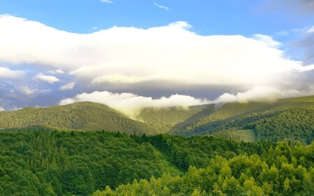 Carpathian mountain summer landscape with white clouds on the skyの写真素材