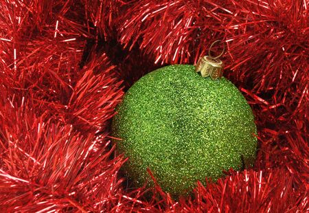 Cristmas holiday decor with green sphere and red tinselの写真素材