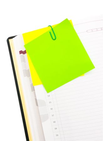 Post-it on the note book with green clipの写真素材