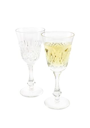Set from two crystal wine glasses, one full and one emptyの写真素材