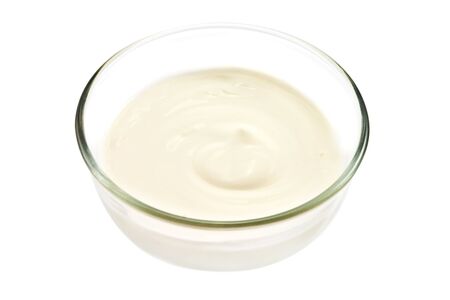 Glass bowl with sour cream on the whiteの写真素材