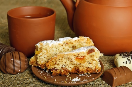 Clay teapot with sweetsの写真素材