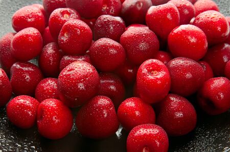 Sweet cherries on black dishの写真素材
