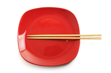 Red plate with chinese sticksの写真素材