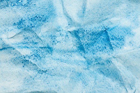 Texture from  blue watercolor stains on crumpled  paper