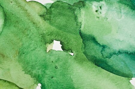 Texture from green and yellow watercolor stains on white paperの写真素材