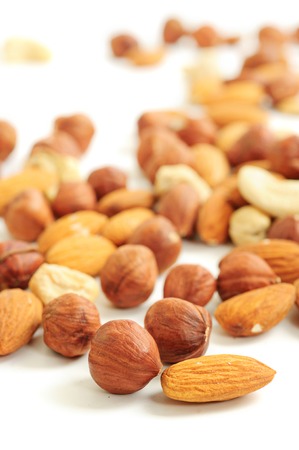 Background from various kinds of nuts (almond, hazelnut, cashew, Brazil nut) on whiteの写真素材