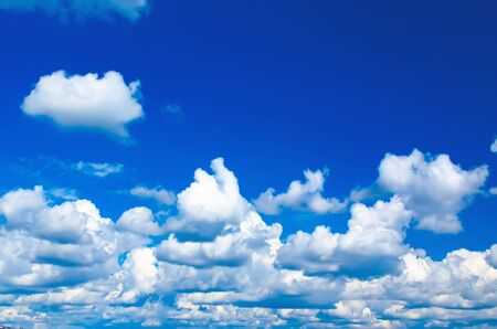 Blue sky with the fluffy white clouds, natural background