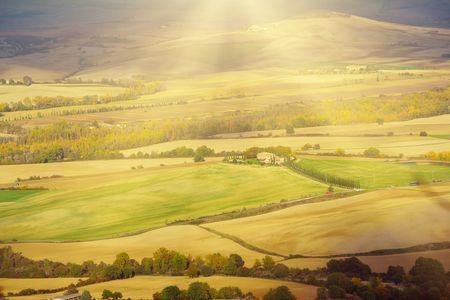 Wavy fields in Tuscany at sunet, Italy. Natural outdoor seasonal autumn background with sun shiningの写真素材