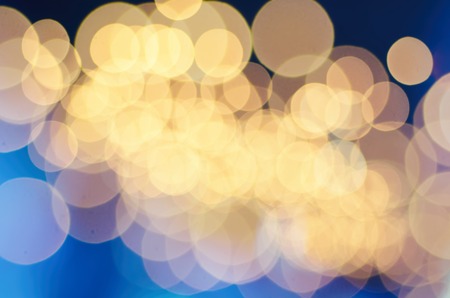 Christmas shiny glitter light abstract bokeh in golden colors, seasonal holiday blurred backgroundの写真素材