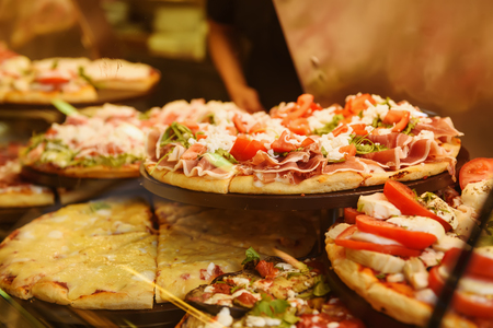 True italian pizza in the showcase of pizzeria in Florence, Italy. Food background.の写真素材