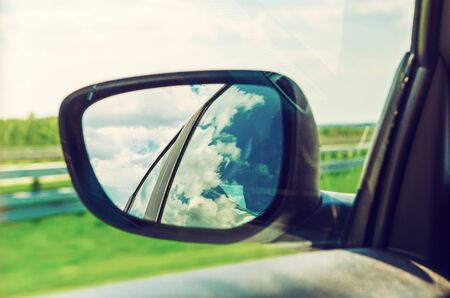 Landscape in the sideview mirror of a carの写真素材