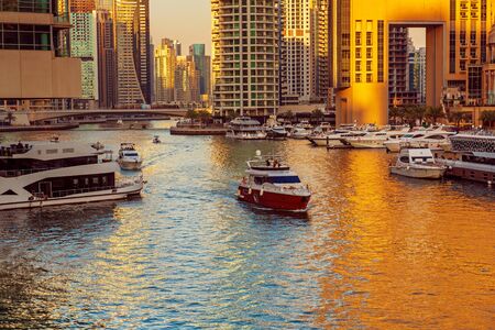 Dubai Marina before sunset with skyscrapers, boats and reflections in the water, United Arab Emiratesの写真素材