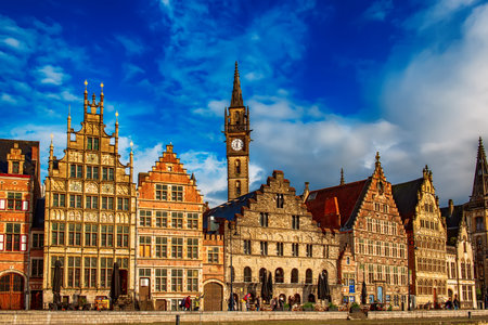 Ghent city historical center, tourists boats and colorful buildings on Leie river bank, Belgiumの写真素材
