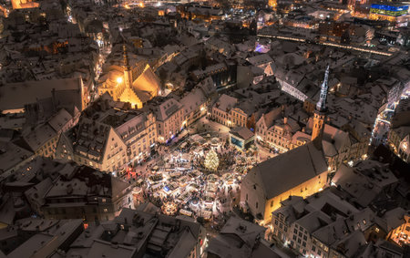 Aerial night View of Tallinn with the Town Hall Square in winter, roofs with snow, Christmas moodの写真素材