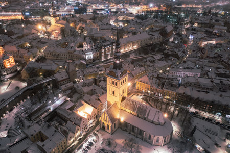 Aerial night View of Tallinn in winter, roofs are covered with snow, Christmas moodの写真素材