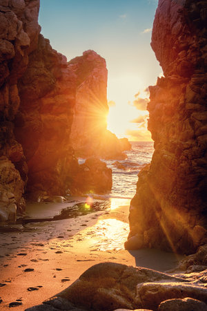 Praia da Ursa beach, Sintra-Cascais Natural Park, Portugal, cliffs in the sea at sunsetの写真素材