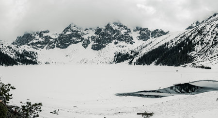 Frozen Lake Morskie Oko or Sea Eye Lake in Poland at Winter. Panoramic viewの写真素材