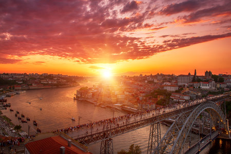 Scenic view of Porto city during sunset with a bridge over the river in Portugal.の写真素材