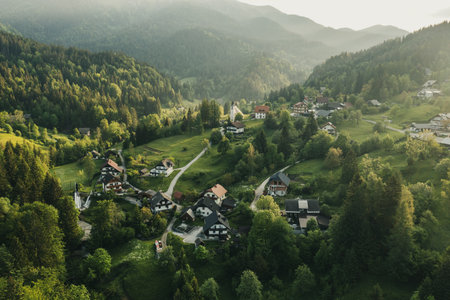 Calm idyllic village in Slovenian mountains at sunrise, summer travel conceptの写真素材