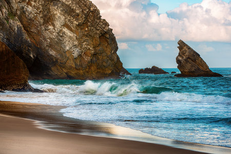 Praia da Adraga Coastal Archway in Sintra Portugal, beautiful beach with rocks in the sea oceanの写真素材