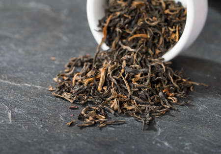 Elite black tea spilled from the containerの写真素材